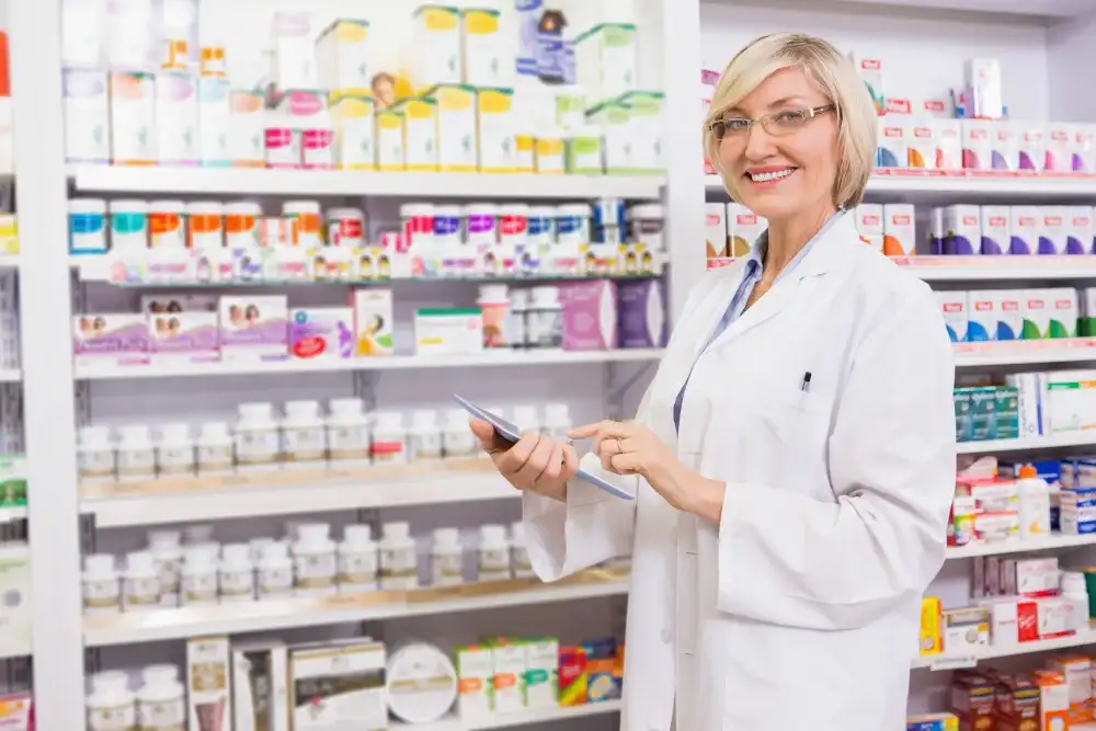 Pharmacist at Elite Pharmacy-RX helping a patient with medication adherence and refill management.